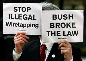 A protestor holds two signs demanding an end to illegal wiretapping and accusing Bush of breaking the law.